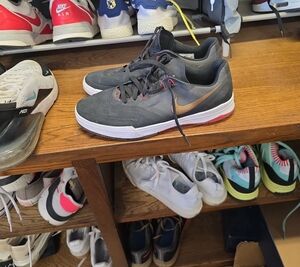 Nike Men's Dark Gray Athletic Sneakers with Bronze Swoosh and Red Accents